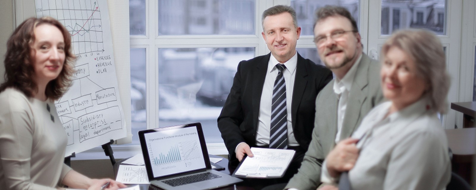 People Gathered Around Desk In Office 